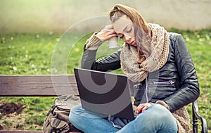 Young student Using laptop in park