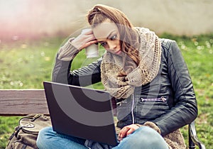 Young student Using laptop in park