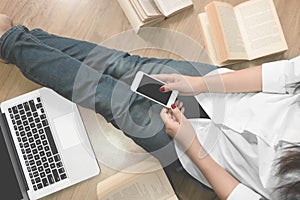 Young student using smart phone at the library