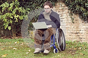 Young student on a wheelchair at the park