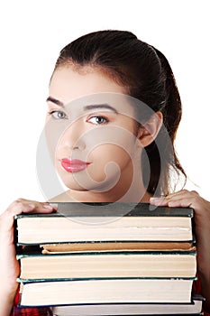 Young student woman eith stack of books