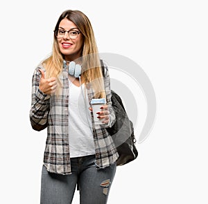 Young student woman with headphones and backpack