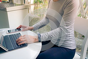 Young student women wearing smart band using tablet computer