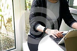 Young student women wearing smart band using tablet computer
