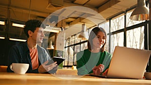 Young students collaborating on project in university library colleagues working in modern coworking