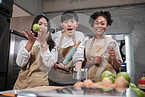 Young students in cooking class smiling, learning fun culinary courses together