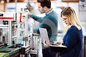 Young students of electronics working on project