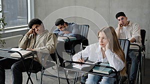 Young students employees workers unmotivated staff sitting in classroom listening boring lecture tedious coach teacher