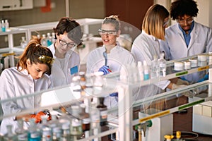 Young students enjoy working in a laboratory. Science, chemistry, lab, people