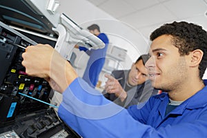 Young students in laboratory using 3d printer