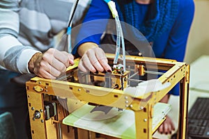 Young students researchers using an innovative 3D printer