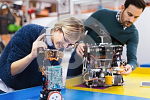 Young students of robotics working on project