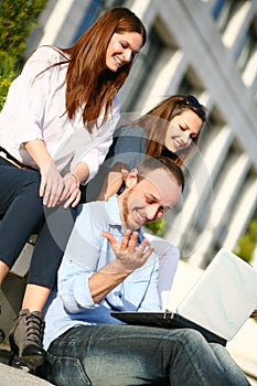 Young students smiling outside