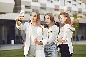 Young students on a student campus with a phone