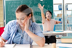 The young students taking the math exam in classroom