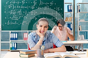 The young students taking the math exam in classroom
