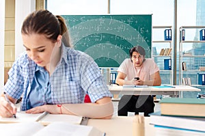 The young students taking the math exam in classroom