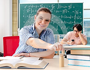 The young students taking the math exam in classroom