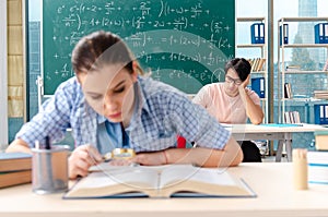 The young students taking the math exam in classroom