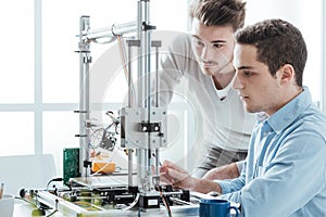 Young students using a 3D printer photo