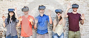 Young students wearing virtual reality glasses outdoor - Happy people having fun with new technology vr headset goggles - New