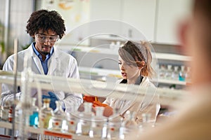 Young students working together with chemicals in the laboratory. Science, chemicals, lab, people