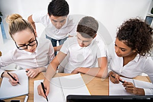 young students writing something