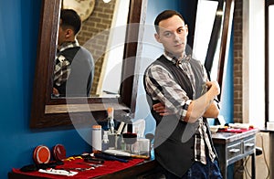 Barber invites to have seat on chair at barbershop