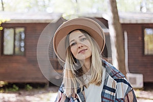 Young stylish caucasian woman 30-35 years old wearing casual clothing shirt and cowboy hat enjoys life at morning during