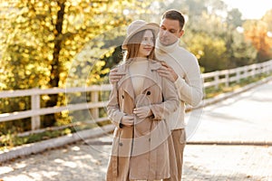 Young stylish couple lovers are hugging in the autumn park. Lovely romantic moment between man and woman in love