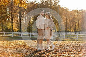 Young stylish couple lovers are hugging in the autumn park. Lovely romantic moment between man and woman in love. Happy