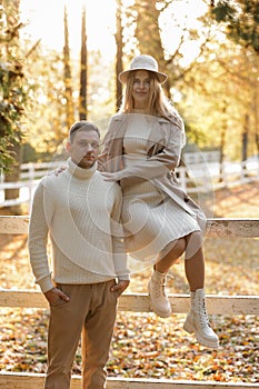 Young stylish couple lovers are hugging in the autumn park. Lovely romantic moment between man and woman in love. Happy