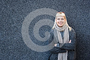 Young stylish cute hippie woman standing against black wall on the street. Millennial hipster girl portrait outdoor, outside of