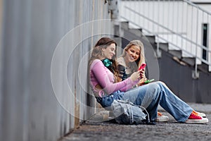 Young stylish generation Z girls spending time outdoors after school.