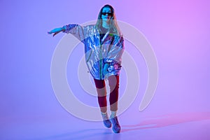 Young stylish girl dancing in the Studio on a colored neon background. Music dj poster design.