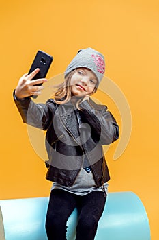 Young stylish girl taking selfie