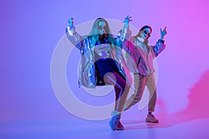 Young stylish girls dancing in the Studio on a colored neon background. Music dj poster design.