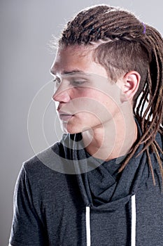 Young stylish guy with dreadlocks collected in bunch.