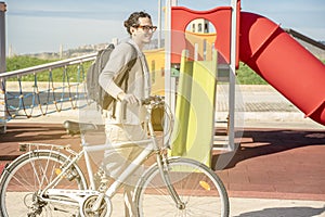 Young stylish guy rides a bicycle