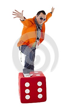 Young stylish guy standing on the dice