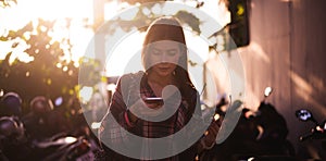 Young stylish happy hipster woman traveling around the world wearing aviator sunglasses, denim shirt, tropical island