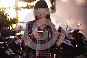 Young stylish happy hipster woman traveling around the world wearing aviator sunglasses, denim shirt, tropical island