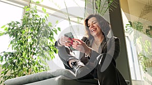 Young stylish millennial woman using her mobile phone, typing