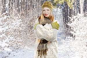 Young stylish smiling blonde woman in variegated melange knitted