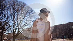 Young stylish woman in hat and coat. Trending girl on a walk