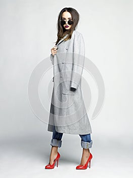 Young stylish woman in oversize gray coat