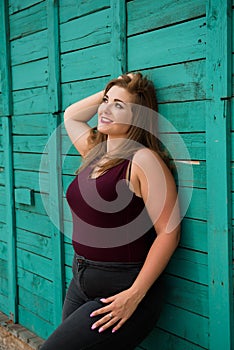 Young stylish woman walking in the city street. Spring fashion outfit, elegant look. Plus size model