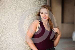 Young stylish woman walking on the city street in summer. Plus size model.