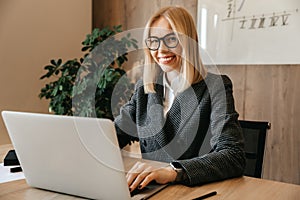 A young successful business woman sits at a workplace in her office as a company director. Business center worker