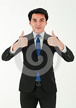 Young successful businessman in formal gives two thumbs up with trust and confident while standing on white background